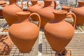 Orange clay vases outside at pottery