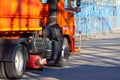 Orange cleaning truck with a brush vacuum cleaner for cleaning city streets Royalty Free Stock Photo