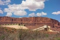 Orange cliffs behind a potash factory in the desert