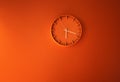 Orange clock showing time. time concept with watch or clock on white wall Royalty Free Stock Photo
