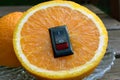 Orange close up with with inserted power switch. Royalty Free Stock Photo