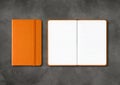 Orange closed and open lined notebooks on dark concrete background Royalty Free Stock Photo