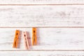 Orange clothes peg on wooden table. Royalty Free Stock Photo