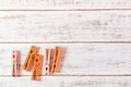 Orange clothes peg on wooden table. Royalty Free Stock Photo