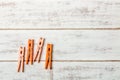 Orange clothes peg on wooden table. Royalty Free Stock Photo