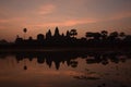 Orange cloud sunrise over famous angkor wat temple with lake and reflection in the water with lillypad Royalty Free Stock Photo