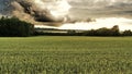 Sunset dark clouds green field Royalty Free Stock Photo