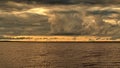 Sunset and storm clouds over lake Royalty Free Stock Photo