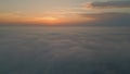 Orange cloudy sky horizon aerial view. Golden skyline over white fluffy clouds Royalty Free Stock Photo