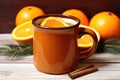 orange and clove spiced cider in ceramic mug