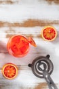 Orange cocktail with blood oranges and a strainer, shot from above Royalty Free Stock Photo