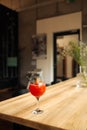 Orange cocktail with grapefruit, ice and rosemary in a transparent glass on a wooden table at style cafe Royalty Free Stock Photo