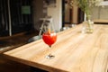 Orange cocktail with grapefruit, ice and rosemary in a transparent glass on a wooden table at style cafe Royalty Free Stock Photo