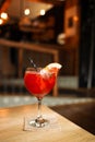 Orange cocktail with grapefruit, ice and rosemary in a transparent glass on a wooden table at style cafe Royalty Free Stock Photo