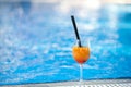 Orange cocktail on swimming pool background.Summer vacation concept. Refreshing beverage.horizontal shot. copy space Royalty Free Stock Photo