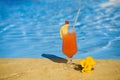 Orange cocktail and a yellow flower Royalty Free Stock Photo