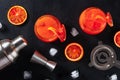 Orange cocktails with bar accessories, overhead shot on a black background Royalty Free Stock Photo