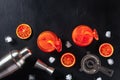 Orange cocktails with blood oranges, a shaker, a jigger, and a strainer Royalty Free Stock Photo