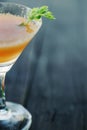 Orange coctail on black wooden table at blurred background