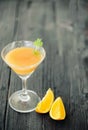 Orange coctail on black wooden table at blurred background