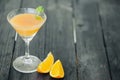 Orange coctail on black wooden table at blurred background