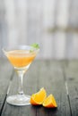 Orange coctail on black wooden table at blurred background