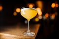 Orange coctail on blurred background with lights