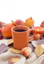 Orange coffee cup on the autumn fall leaves