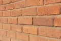 Orange color brick wall closeup perspective shot. Brick texture horizontal background