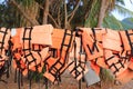 Orange color life jackets hanging in the row Royalty Free Stock Photo