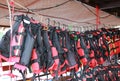 Orange color life jackets hanging in the row on boat station Royalty Free Stock Photo