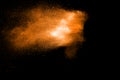 Orange color powder explosion on black background Royalty Free Stock Photo