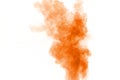 Orange color powder explosion cloud on white background. Orange dust particle splash Royalty Free Stock Photo