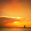 seascape image with shiny sea and sailboat over cloudy sky Royalty Free Stock Photo