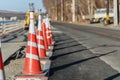 Orange color traffic cones in row for road maintenance work site