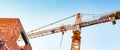 Orange colored building construction crane. Royalty Free Stock Photo