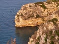 Orange colored cliff above sea
