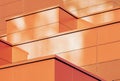 Orange colored geometric background of metal building facade