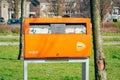 Orange colored public mailbox