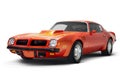 Orange colored Side front view of a 1974 Pontiac Trans Am Brand muscle car on a white background studio shot