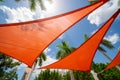 Orange colored sun shade in a park outdoors