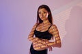 Orange colored woman word. Beautiful young woman is in projector neon lights in the studio