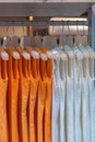 Orange colors shirts hang in a wooden closet at modern home decoration Royalty Free Stock Photo