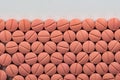 Orange colour round pills on white background.