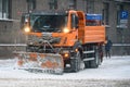 Orange coloured Snow Removal Car MAN, during snowfall