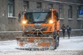 Orange coloured Snow Removal Car MAN, during snowfall