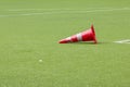 Orange cone falling on football field Royalty Free Stock Photo