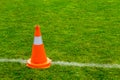 Orange cone on grass field Royalty Free Stock Photo