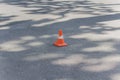 Orange cone on the pavement
