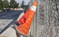 Orange cones against a fence Royalty Free Stock Photo